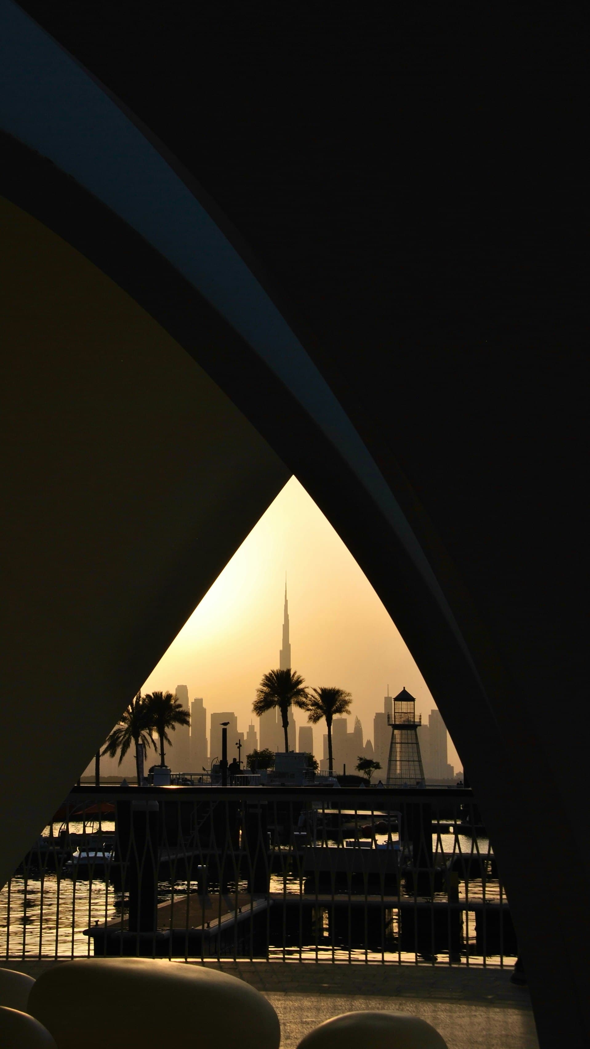 The Dubai skyline seen through an archway at sunset